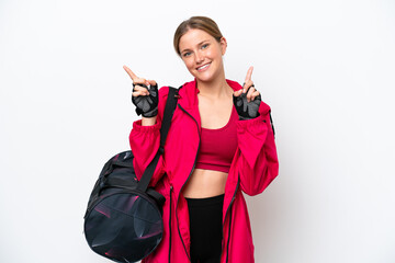 Young caucasian sport woman isolated on white background pointing finger to the laterals and happy