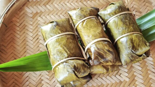 Khao Tom Mud, Traditional Thai dessert sticky rice, coconut milk and banana wrapped in banana leaves