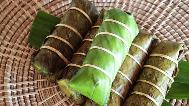 Khao Tom Mud, Traditional Thai dessert sticky rice, coconut milk and banana wrapped in banana leaves