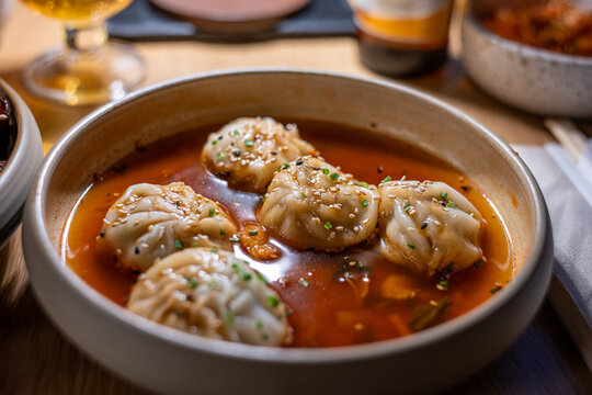 Mandu dumplings in hot Buldak sauce served at a Korean restaurant