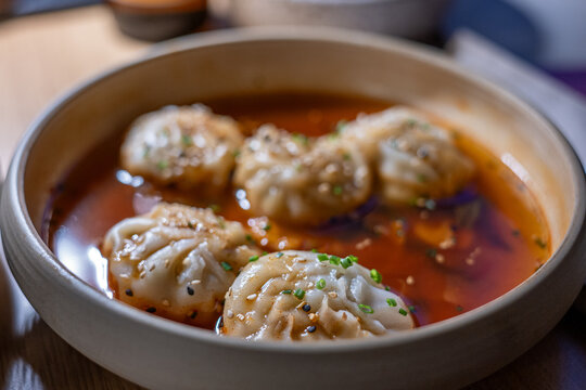 Mandu dumplings in hot Buldak sauce served at a Korean restaurant