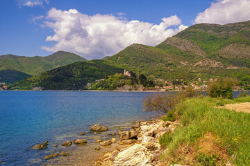 Beautiful Mediterranean landscape. Montenegro, Adriatic Sea. View of  Bay of Kotor near Verige Strait. Kamenari village and church of Holy Sunday in distance