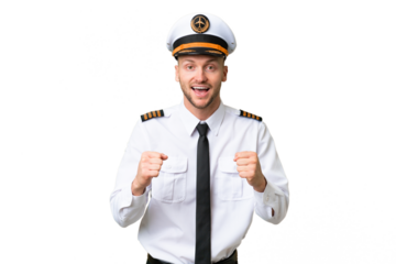Airplane pilot man over isolated background celebrating a victory in winner position