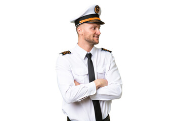 Airplane pilot man over isolated background with arms crossed and happy