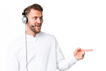 Telemarketer caucasian man working with a headset over isolated chroma key background pointing finger to the side and presenting a product
