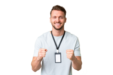 Young caucasian man with ID card over isolated chroma key background celebrating a victory in winner position