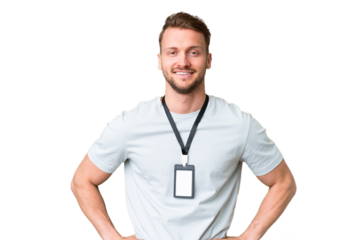 Young caucasian man with ID card over isolated chroma key background posing with arms at hip and smiling