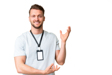 Young caucasian man with ID card over isolated chroma key background extending hands to the side for inviting to come
