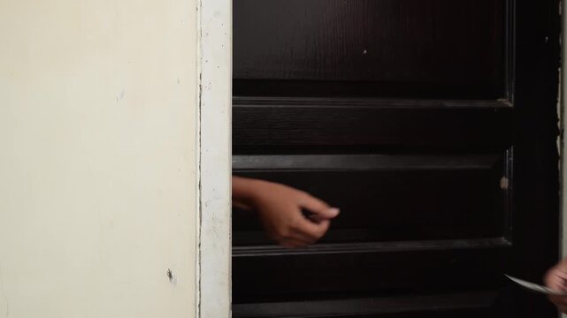 Illustration of an illegal drug transaction taking place discreetly through the slightly open dark wooden door of a house.