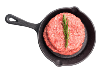 Ready for cooking Raw beef meat patties, cutlets with herbs  in pan isolated on white background