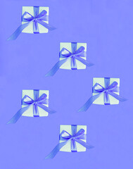 Gift boxes with tied purple bow on a purple background. Flat lay. Top view.
