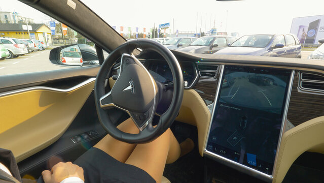 CLOSE UP: Unknown businesswoman presses a button and the autonomous parks itself