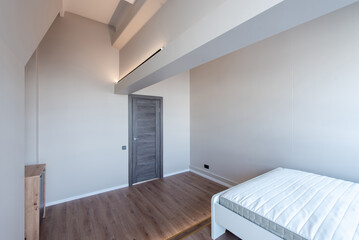 Minimalist Bedroom Interior with Light Gray Walls and a Wooden Flooring Style. Home Interior