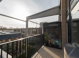 Modern Apartment Balcony Overlooking Urban Rooftops in Daylight. Home Loft Exterior. Industry Area