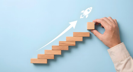 Business growth concept with wooden blocks and rocket