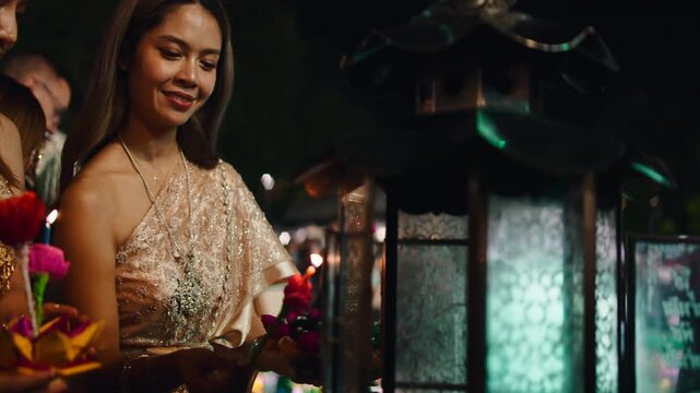 Thai women in traditional dress celebrating loi krathong festival