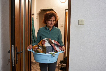 Woman carrying laundry basket © Xalanx