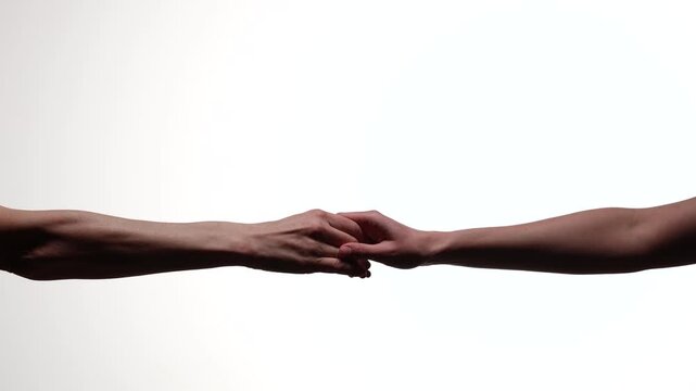 Two outstretched arms with hands gently clasping in a tender gesture, centered against a white backdrop with copy space