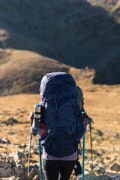 Solitary backpacker descending quietly into expansive alpine valley