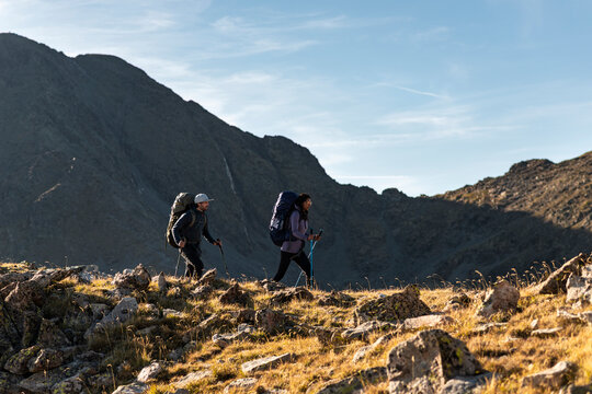 Trekkers walking in silence along alpine slope