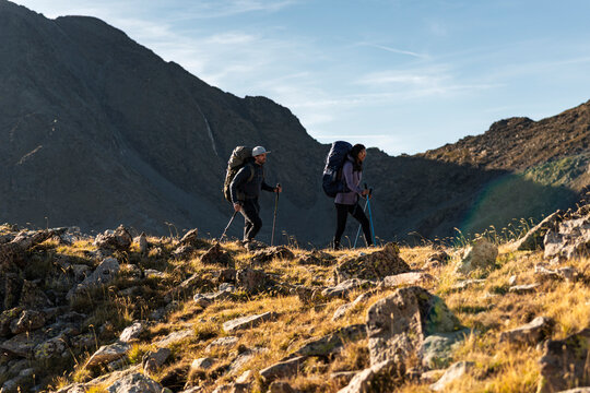 Committed mountain hikers moving forward through rugged terrain