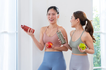 Happy fitness friends enjoying healthy snacks after exercise
