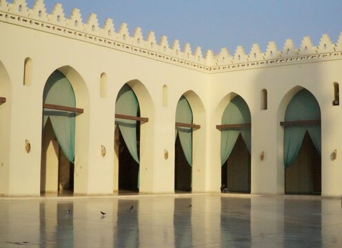 A photo inside Al-Hakim mosque with its famous arches and green curtains in Cairo, Egypt.