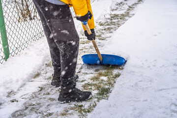 Removing snow from the pathway and street, winter cleaning