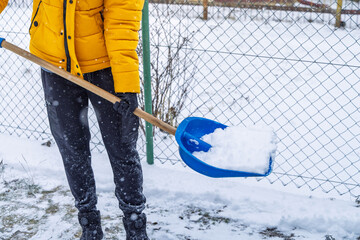 Removing snow from the pathway and street, winter cleaning