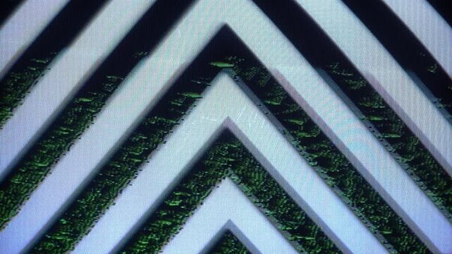 Abstract pattern of repeating black and light blue chevron stripes with a textured, digital noise effect.