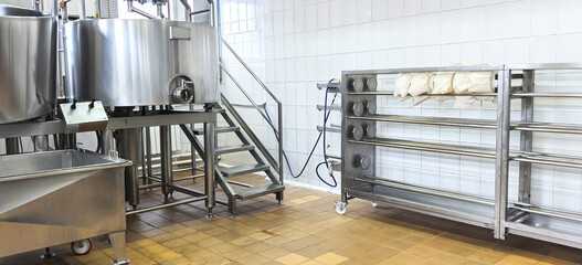 Industrial kitchen setup with metal equipment and storage area for food preparation tasks in a commercial space