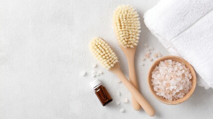 Skincare Exfoliation Ritual concept. Spa accessories with brushes, salt, and a towel on a textured background.