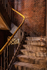 Derelict factory stairwell with brick walls
