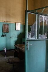 Abandoned office interior with broken glass door