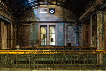 Abandoned industrial hall interior with balcony