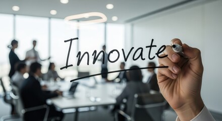 Business team brainstorming with hand writing 'Innovate' on glass wall