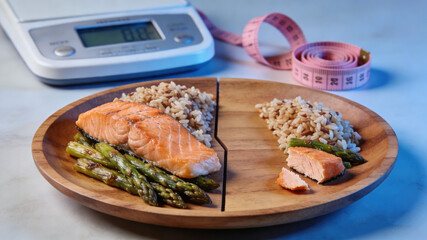 Shrinking food portions on a plate with a weight scale and measuring tape, symbolizing diet and weight loss efforts.