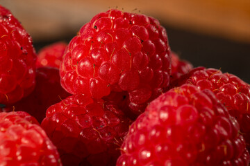 Fresh appetizing ripe raspberries in a detailed macro shot showing texture and vibrant red color