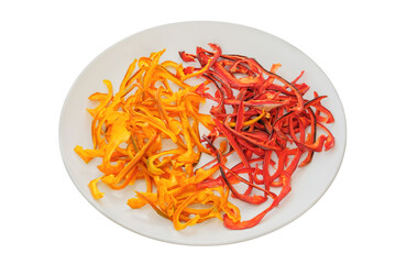 Freeze-dried vegetable for travel. Dried sweet peppers on a ceramic plate isolated on a white background. Various dry of sweet peppers.