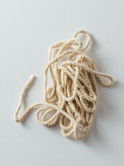 Twisted Natural Rope Stacked on Light Background for Textures and Crafts