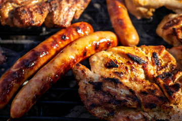 Pork chops, steak, sausages on barbecue grill