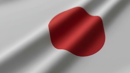 A Japanese flag waving in the wind with a red circle on a white background