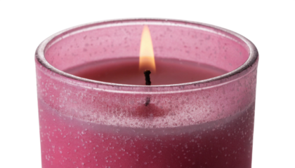 Candle flame burning in pink glass jar isolated on transparent background