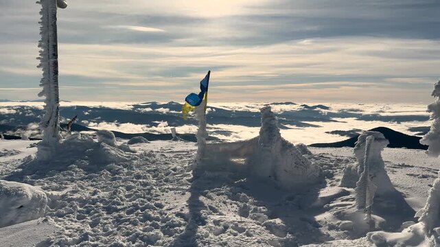 View from Hoverla in winter, Ukraine, Carpathians. Beautiful landscape with blue Carpathian peaks, morning fog in the gorges of Transcarpathia. Snow figures on a peak.