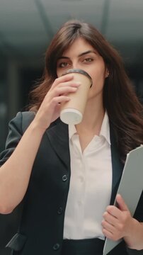 Empowered confident woman walking with coffee showing motivation success independence leadership and ambition symbolizing career growth modern female empowerment financial freedom concept