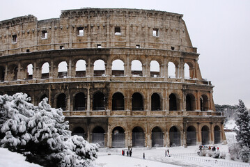 Winter in Rome. View of the famous Coliseum covered by snow
