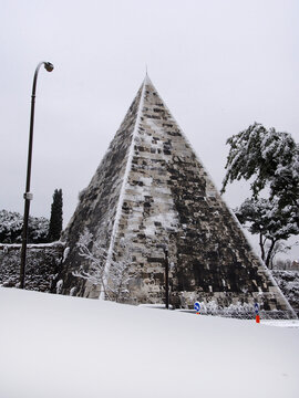 Winter in Rome. View of the Pyramid of Cestius covered by snow