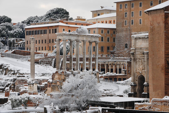 Winter in Rome. View of the Roman Forum ancient ruins covered by snow
