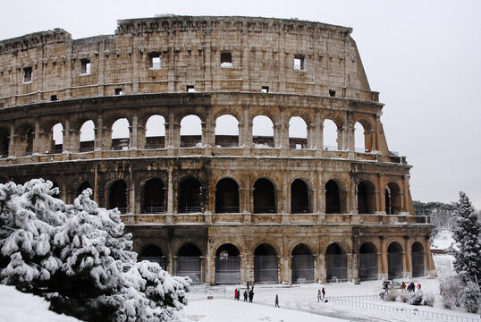 Winter in Rome. View of the famous Coliseum covered by snow