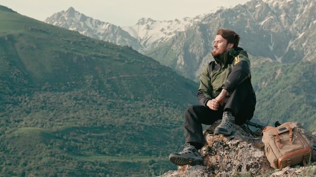 Man sitting on rock with backpack breathing mountain air copy space for text mindfulness freedom calm travel concept relaxation adventure lifestyle happiness outdoor mental balance tranquility